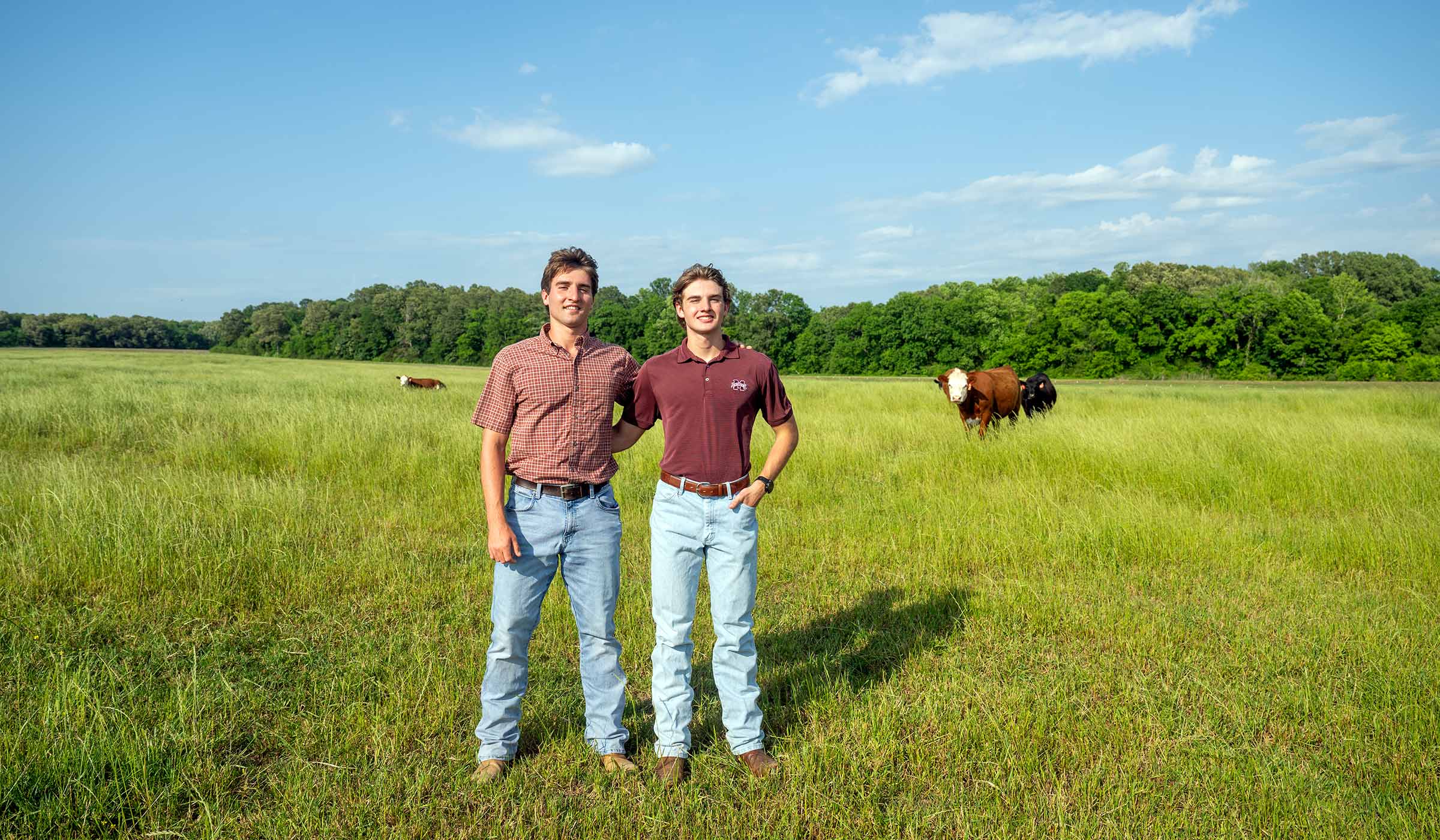 two young man standing in a field